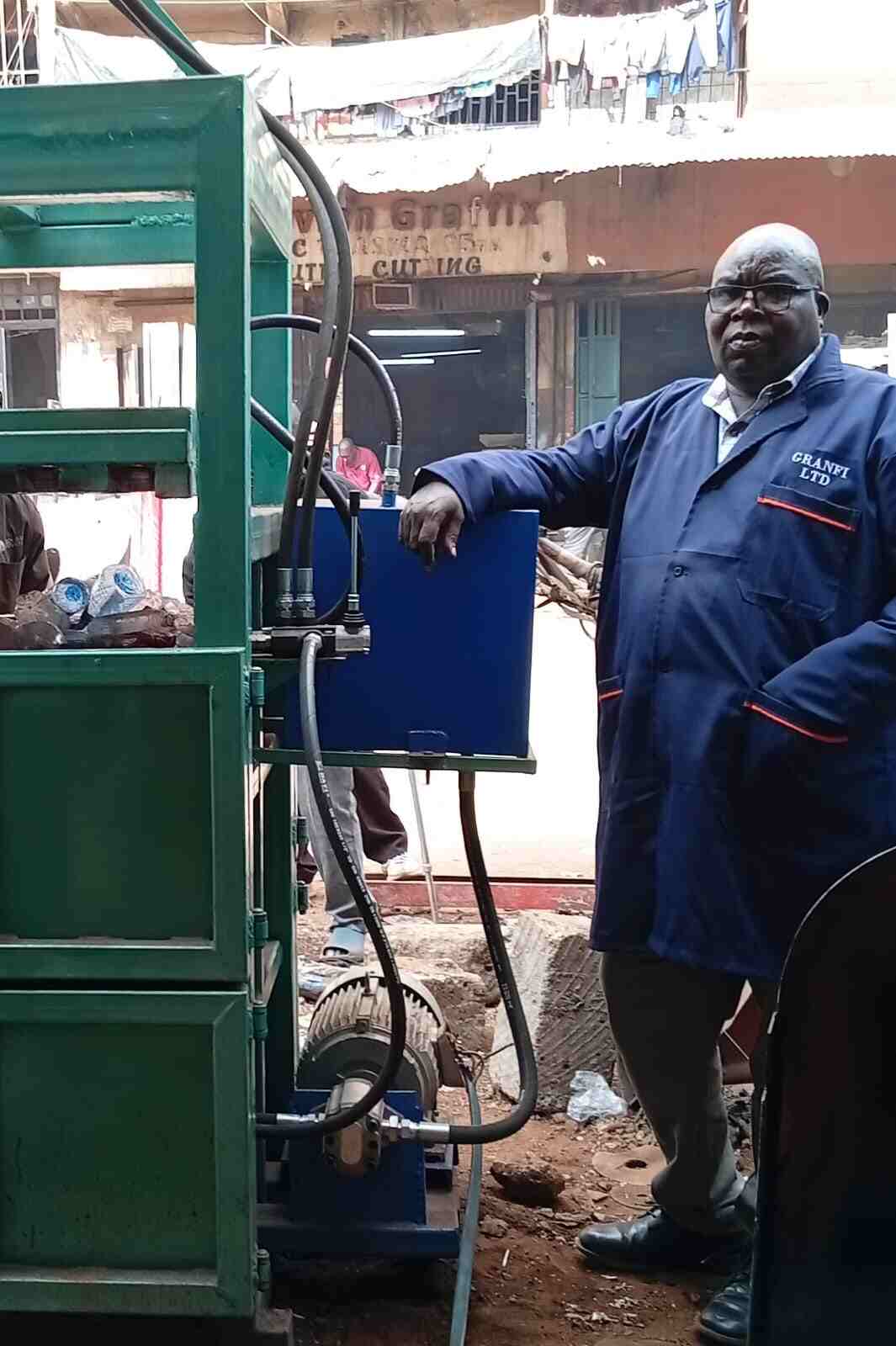 GRANFI engineer with a hydraulic baling machine in the workshop